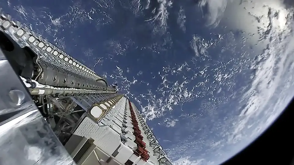 A stack of 60 Starlink test satellites atop a Falcon 9 rocket, close to entering orbit